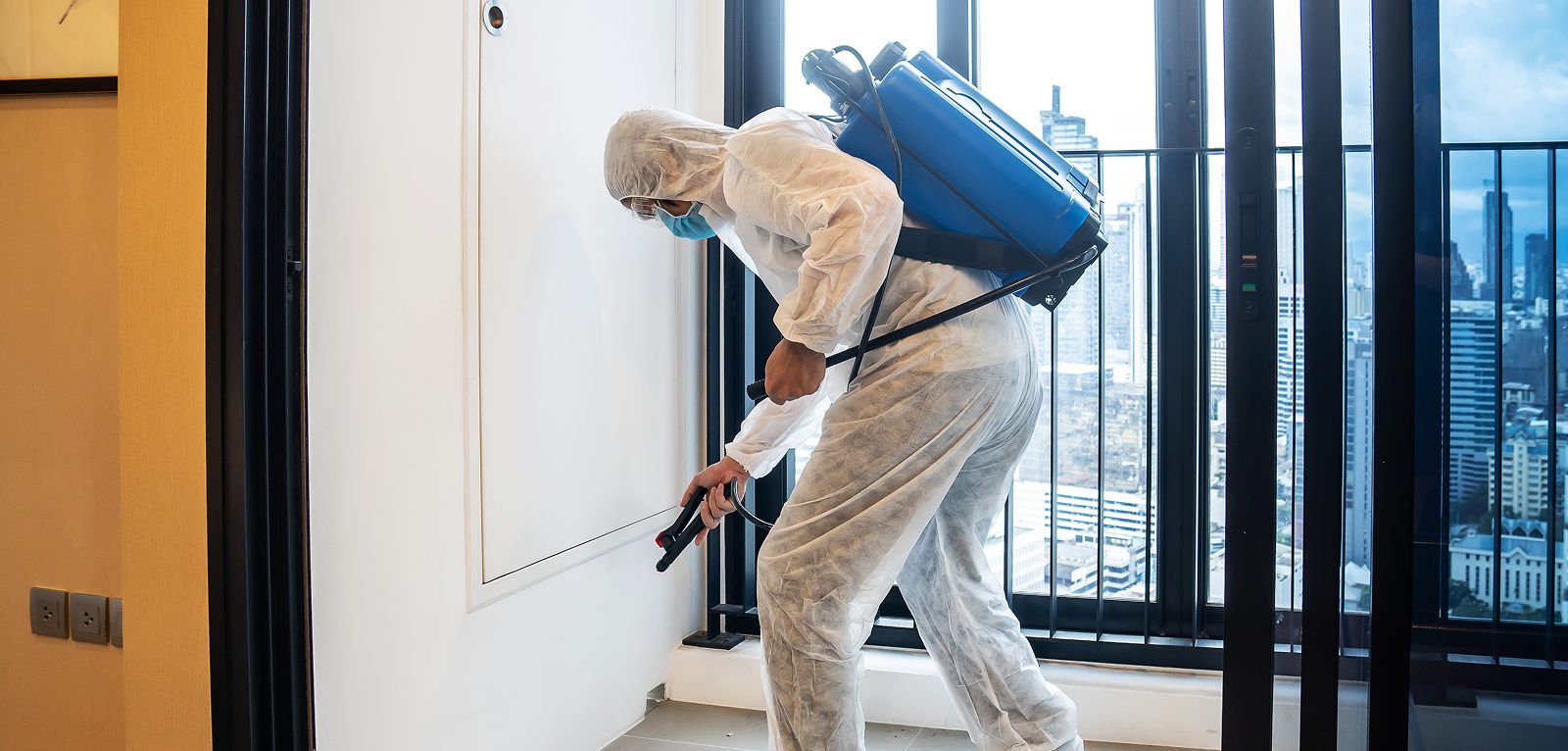A pest control technician treating a home