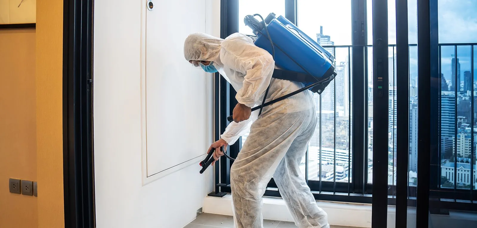 A pest control technician treating a home